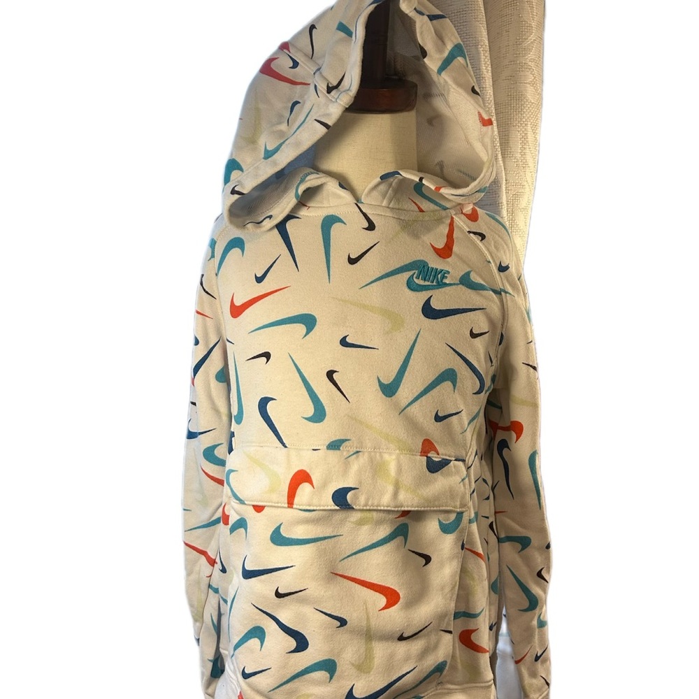 Kids Nike White Hoodie with Multicolor Swooshes.